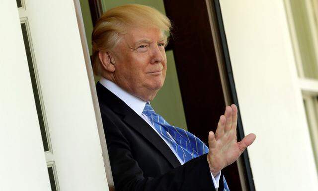 President Donald Trump gestures to the media