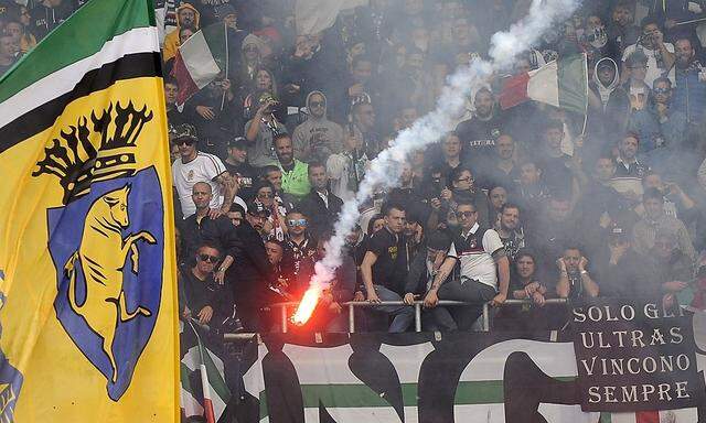 Juventus' supporters look on as a flare is thrown during their Italian Serie A soccer match against Torino in Turin