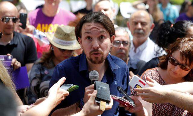 Podemos leader Iglesias, now running under the coalition Unidos Podemos, talks to reporters during a campaign rally for Spain´s upcoming general election in Madrid