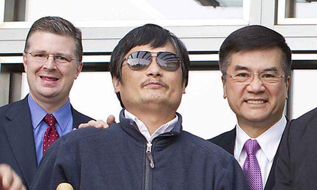 In this photo released by the US Embassy Beijing Press Office, blind lawyer Chen Guangcheng, front le