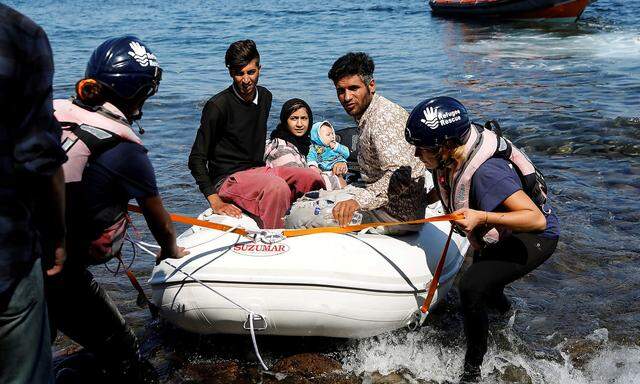 FILE PHOTO: A small inflatable boat carrying migrants from Afghanistan is towed by rescuers of the Refugee Rescue NGO, near Skala Sikamias, on the island of Lesbos