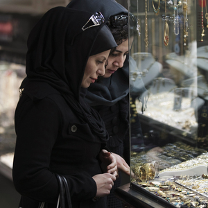 Women look at jewellery at a shop window in a bazaar in northern Tehran