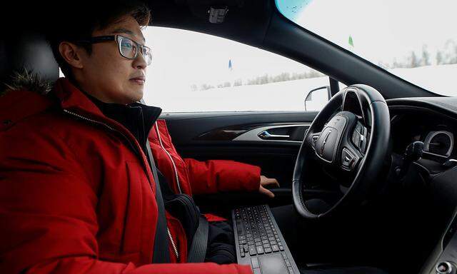 Software engineer Steven Han demonstrates a self-driving car at the Renesas Electronics autonomous vehicle test track in Stratford