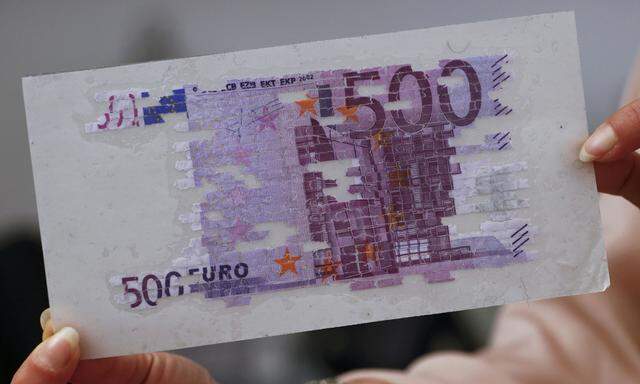 An employee of Austrian central bank (Nationalbank) shows a restored 500 euro banknote at their bank´s headquarters in Vienna