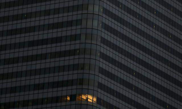 File photo of an office in the HSBC building is seen with a light turned on, in the Canary Wharf business district of east London