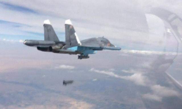 Frame grab shows Russian fighter-bomber droping bomb in air over Syria