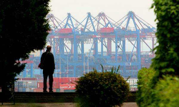 Kräne im Hamburger Hafen verladen Container auf Frachtschiffe.