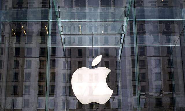 A file of the Apple logo hanging inside the glass entrance to the Apple Store on 5th Avenue in New York City,