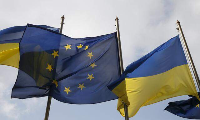 Ukrainian and EU flags fly in front of the Presidential Administration in Kiev