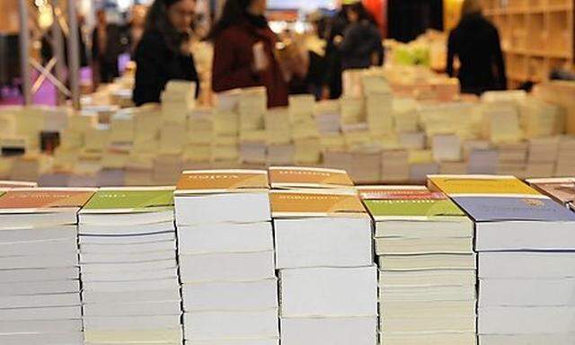 Books are displayed during the installation of the annual Paris Book Fair