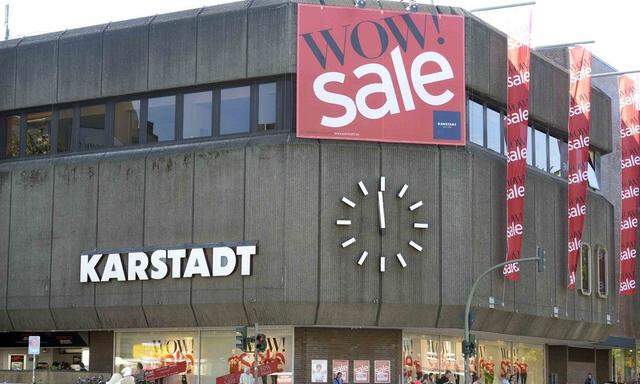 Clock showing one minute to noon is seen at a warehouse of the German department store chain Karstadt in Hamburg