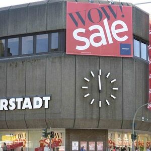 Clock showing one minute to noon is seen at a warehouse of the German department store chain Karstadt in Hamburg