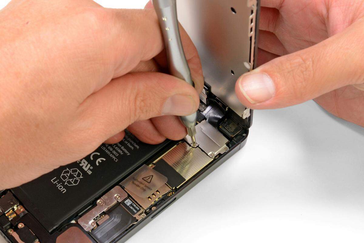 Weitere Schrauben fixieren den Touchscreen-Teil mit dem Rest des iPhone 5.