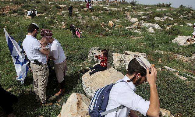 Israeli settlers hold a protest march in West Bank