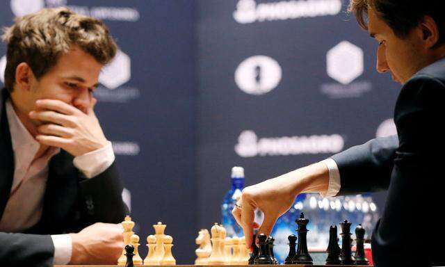 Sergey Karjakin of Russia makes a move against his opponent Magnus Carlsen of Norway during round 12 of the 2016 World Chess Championship match in New York