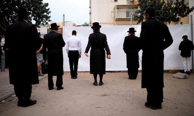 Orthodoxe Juden beten in Ashdod im Freien, bevor eine nächtliche Ausgangssperre in mehreren israelischen Städten in Kraft tritt.