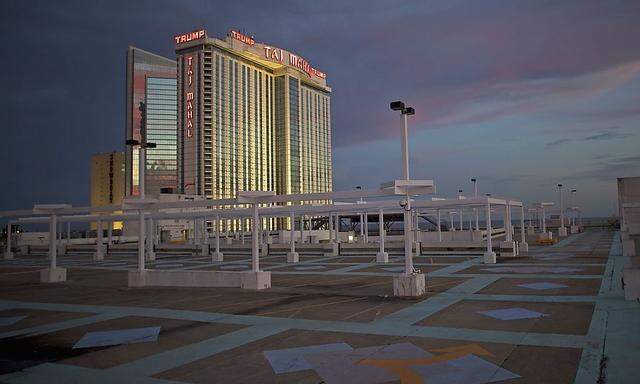The illuminated Trump Taj Mahal Casino is seen from an empty rooftop parking lot at dusk in Atlantic City, New Jersey