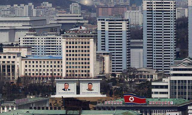File photo shows the current mosaic portrait of the founder of North Korea Kim Il-sung and the new portrait of late leader Kim Jong-il being seen in downtown Pyongyang
