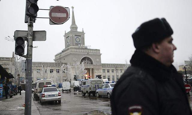 Interior Ministry members stand guard near a train station where explosives were detonated inside the main entrance in Volgograd