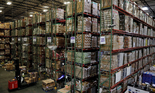 FILE PHOTO: A worker uses a forklift to retrieve products stored inside of a large Amazon fulfillment center in Robbinsville, New Jersey