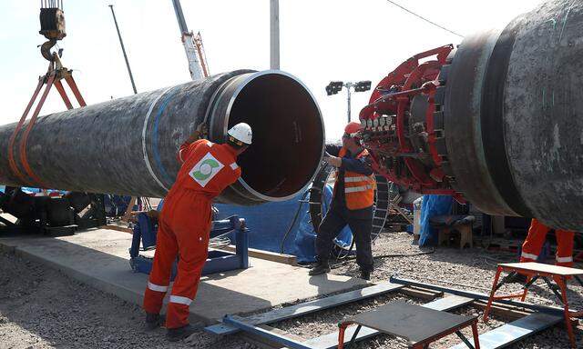 FILE PHOTO: Workers at a Nord Stream 2 gas pipeline construction site near Kingisepp, Russia