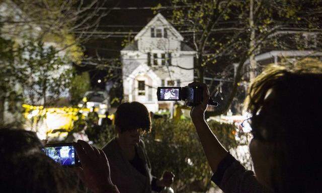 Neighbors use cameras to record images of the boat at 67 Franklin St. where Dzhokhar Tsarnaev, suspect in Boston Marathon bombings, was hiding inside in Watertown