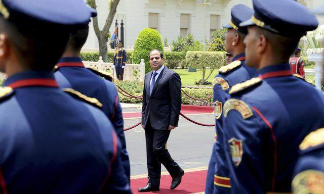 President Abdel Fattah al-Sisi reviews guards of honor after he was sworn in as president of Egypt, at the presidential palace in Cairo