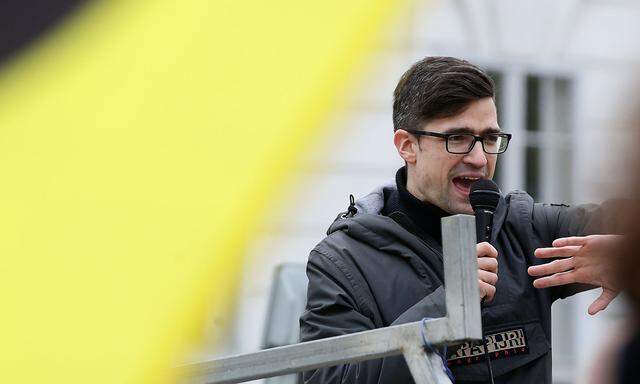 Leader of Austria's Identitarian Movement Martin Sellner speaks during a protest against a police raid at his house, outside the Justice Ministry in Vienna