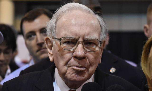 Warren Buffett C receives interviews while he visits the exhibit hall before the Berkshire Hathawa