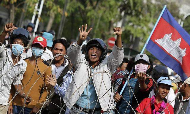 Protesters shout near the Council of Ministers building during a demonstration in central Phnom Penh