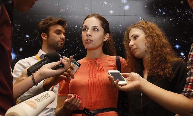 Members of Russian punk rock band Pussy Riot speak to the media after leaving the inaugural Prudential Eye Awards in Singapore