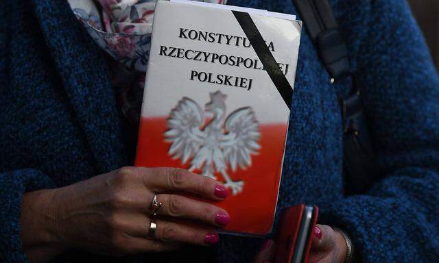 February 17 2019 Krakow Poland An activist holds a copy of the Polish Constitution outside Pol