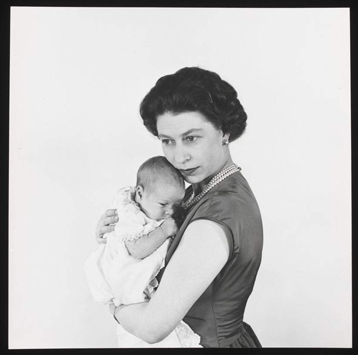 Auch für die ersten Fotografien ihrer neugeborenen Kinder wählte Queen Elizabeth Cecil Beaton. In diesen Bildern porträtierte er sie in einer intimen Atmosphäre, die das Familienleben der Königin zeigten. Queen Elizabeth II mit Prinz Andrew, 1960.