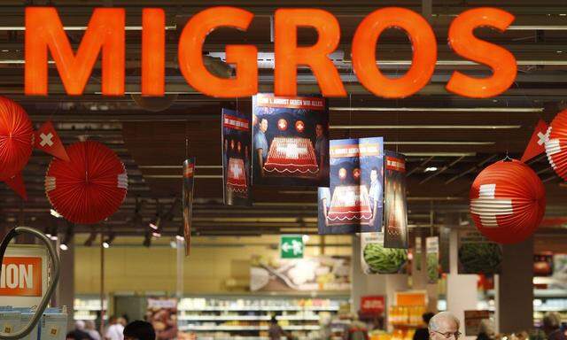 The logo of the supermarket Migros is seen at the entrance of the Shoppyland in Schoenbuehl outside Bern