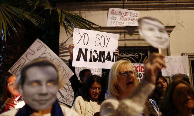 People take part in a peaceful demonstration, honouring late Argentine state prosecutor Alberto Nisman, outside the Argentina Embassy in Mexico City