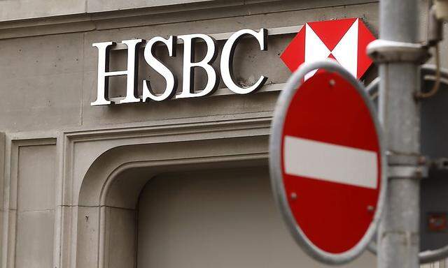A traffic sign is seen in front of a branch office of HSBC bank at the Paradeplatz in Zurich