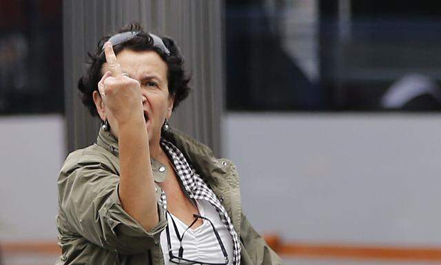 A taxi customer reacts after being hit by eggs during a protest by taxi drivers, in central Brussels