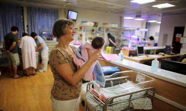 A file picture shows a nurse holding a newborn baby at a nursery in Hadassah Ein Kerem Medical Center in Jerusalem