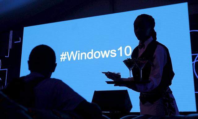 A waitress serves a Microsoft delegate during the launch of the Windows 10 operating system in Kenya's capital Nairobi