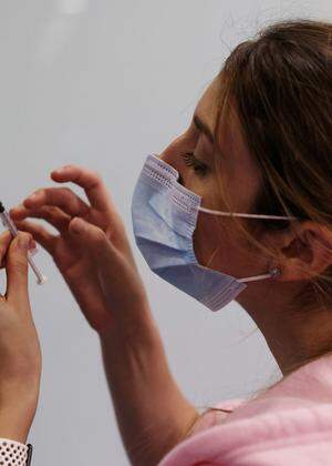 FILE PHOTO: A medical worker prepares to administer a second vaccination injection against the coronavirus disease as Israel continues its national vaccination drive