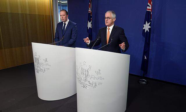 Australian Prime Minister Malcolm Turnbull speaks as he stands with Immigration Minister Peter Dutton during a media conference in Sydney