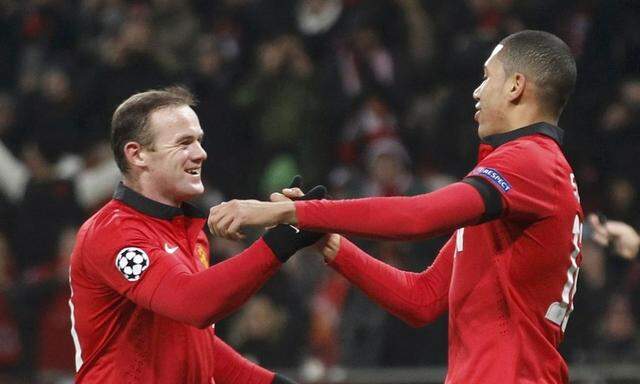 Manchester United's Smalling celebrates with Rooney after scoring against Bayer Leverkusen during Champions League soccer match in Leverkusen