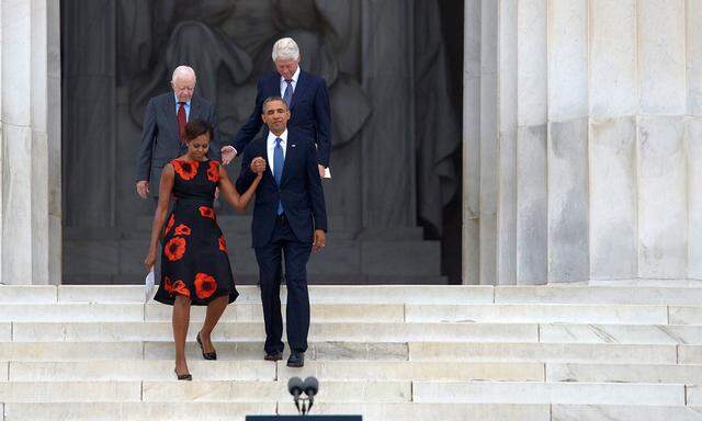 Barack Obama (front R), with First Lady Michelle Obama (front L) and former US presidents Jimmy Carter (back L) and Bill Clinton