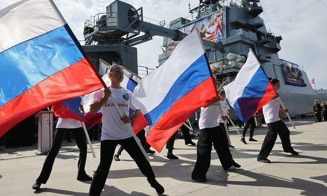 Schüler schwenken vor einem Landungsschiff in der Exklave Kaliningrad die russische Fahne. Von Kindesbeinen an wird der Militarismus eingebläut. 