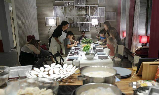 Visitors set a table and cook dinner at the �New ideas for eating� IKEA showroom in Moscow