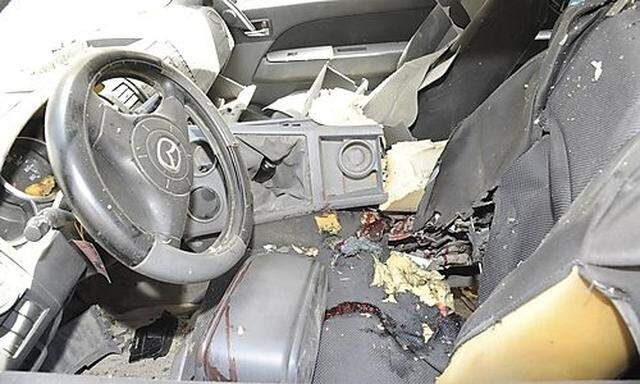 The interior of a car is pictured after a bomb exploded in Damascus