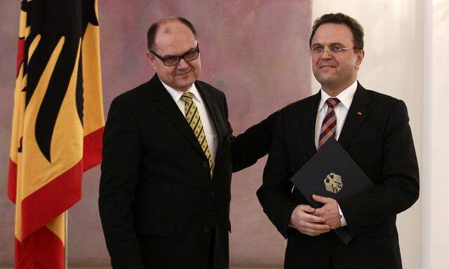 Outgoing German Agriculture Minister Friedrich stands next to new Agriculture Minister Schmidt during the cermony of appointment at Bellevue Castle in Berlin