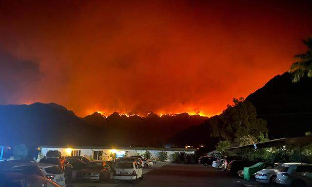 MUGLA PROVINCE, TURKEY - JULY 30, 2021: A wildfire approaches the village of Orhaniye, 28.6km west of the Aegean Sea re