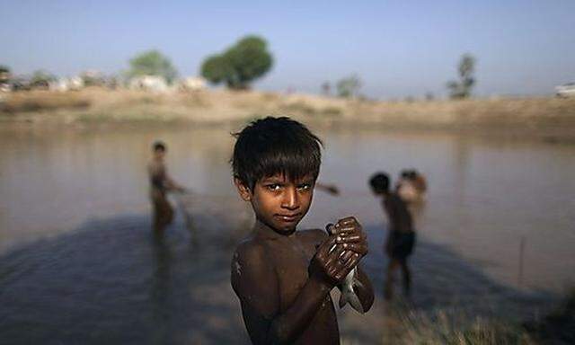 In this Monday, Nov. 1, 2010 picture, Shwun Ali, a boy whose family was displaced by floods, looks on