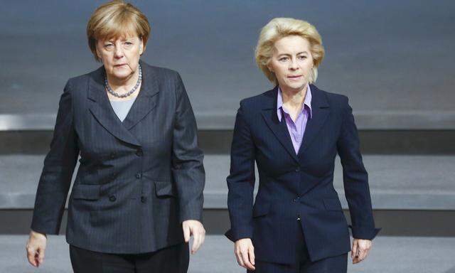 German Chancellor Merkel and Defence Minister von der Leyen walk during a session of the Bundestag, the German lower house of parliament, in Berlin